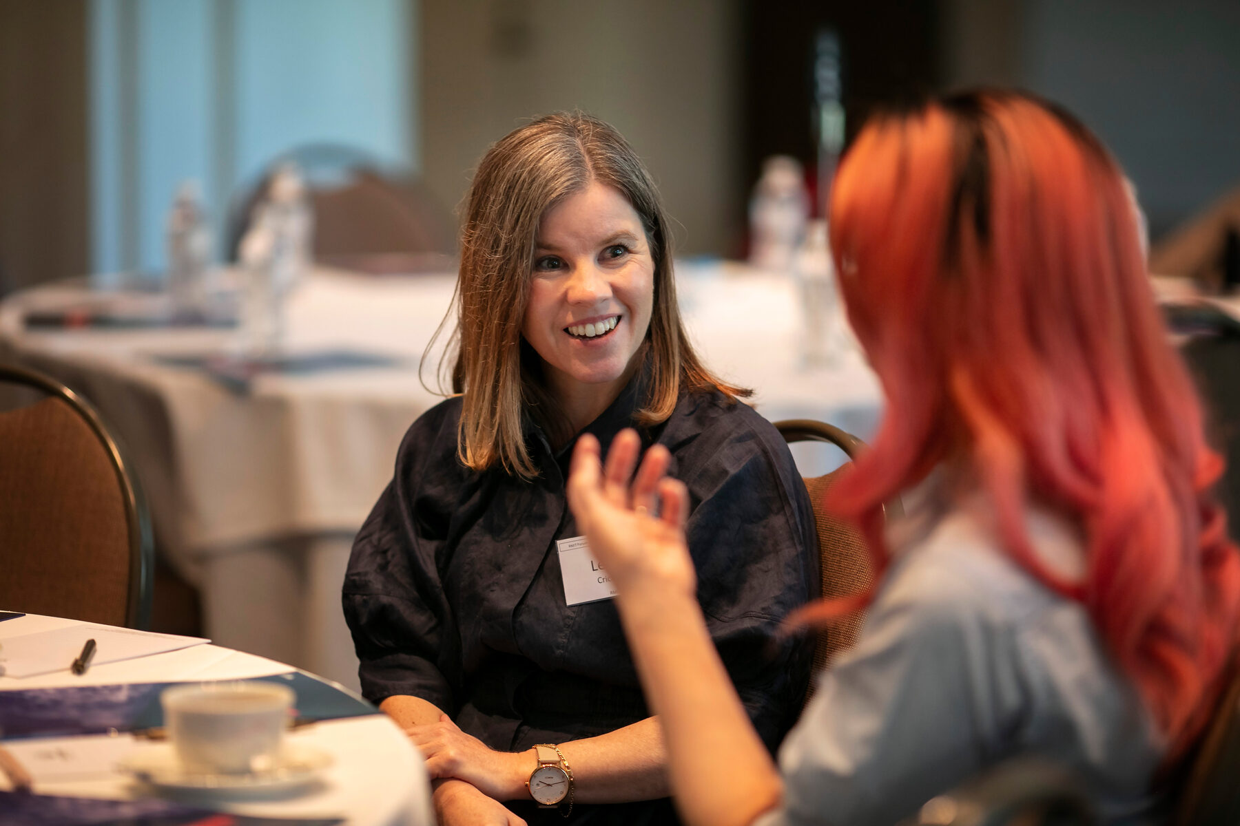 Two participants in conversation at the Melbourne Forum